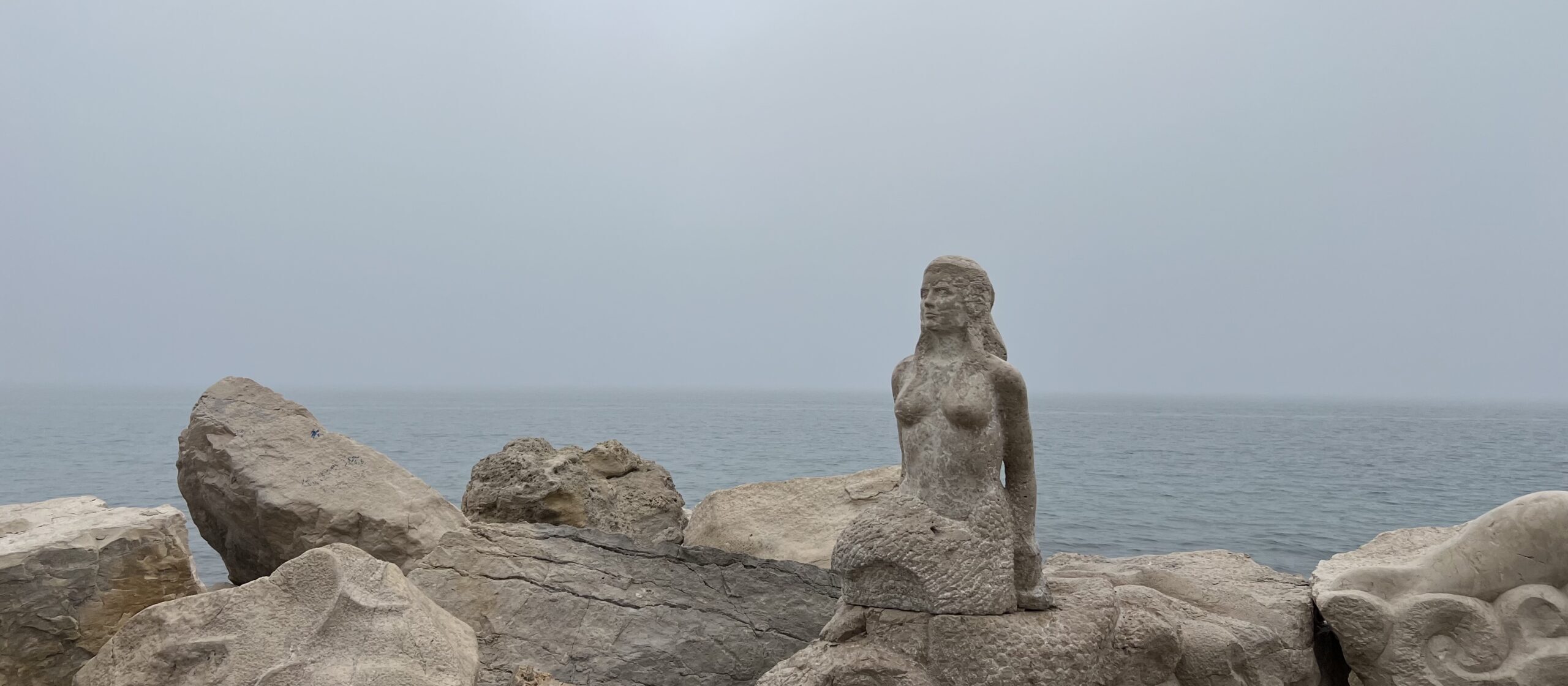 stone lady stone lady with sea background
